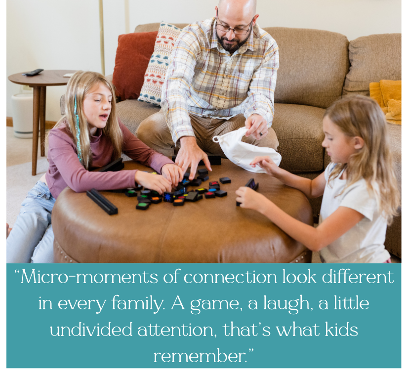 Dad and two daughters playing a game together, dad is listening to daughters, giving undivided attention in an opportunity of connection.