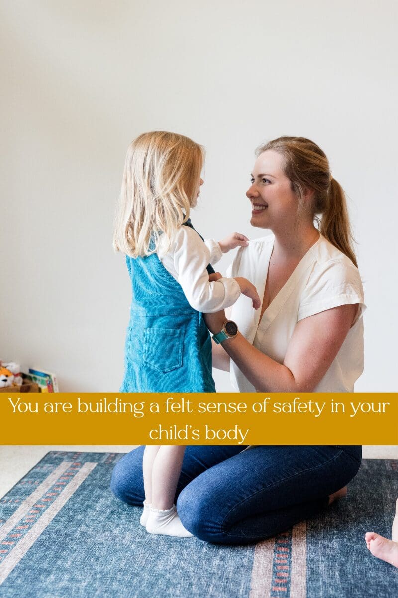 Smiling mother kneeling face to face with her young daughter, with text: You are building a felt sense of safety in your child's body.