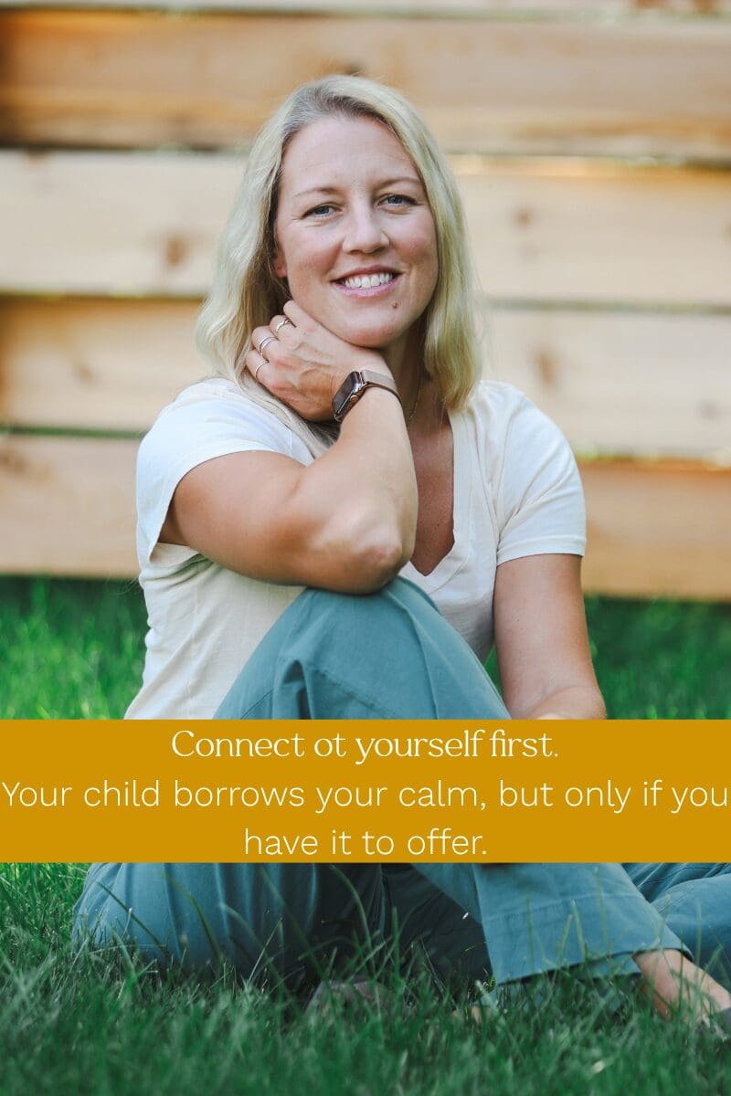 Parent Coach Amy Fink smiling sitting in the grass, with text: Connect to yourself first. Your child borrows your calm, but only if you have it to offer.